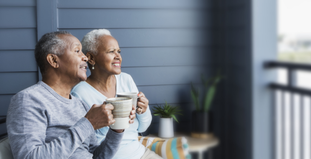 A couple affected by metastatic pancreatic cancer sitting on a porch having coffee.