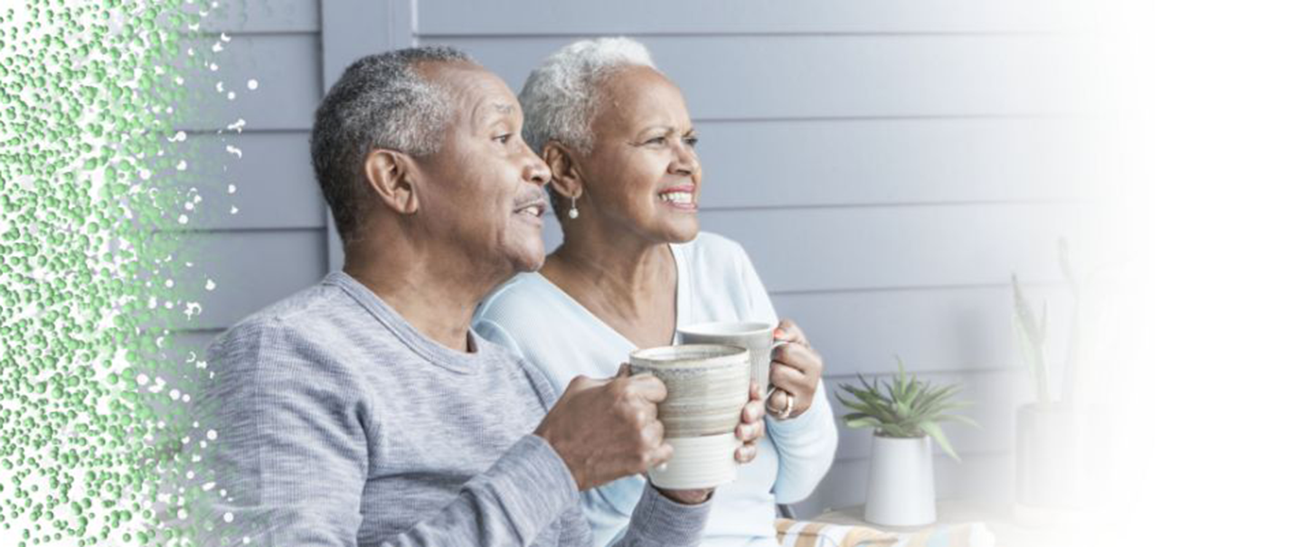 A couple affected by metastatic pancreatic cancer sitting on a porch having coffee