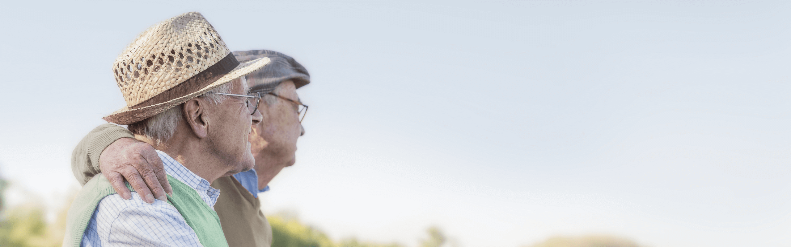 Two older men affected by metastatic pancreatic cancer sitting outside together