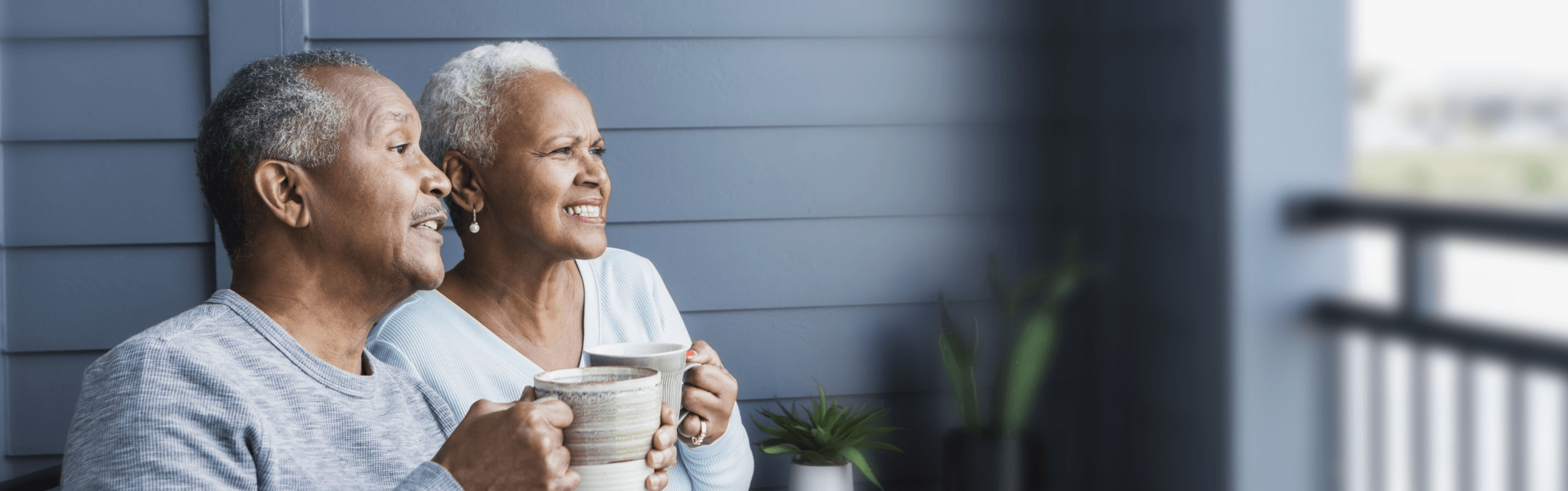 A couple affected by metastatic pancreatic cancer sitting on a porch having coffee
